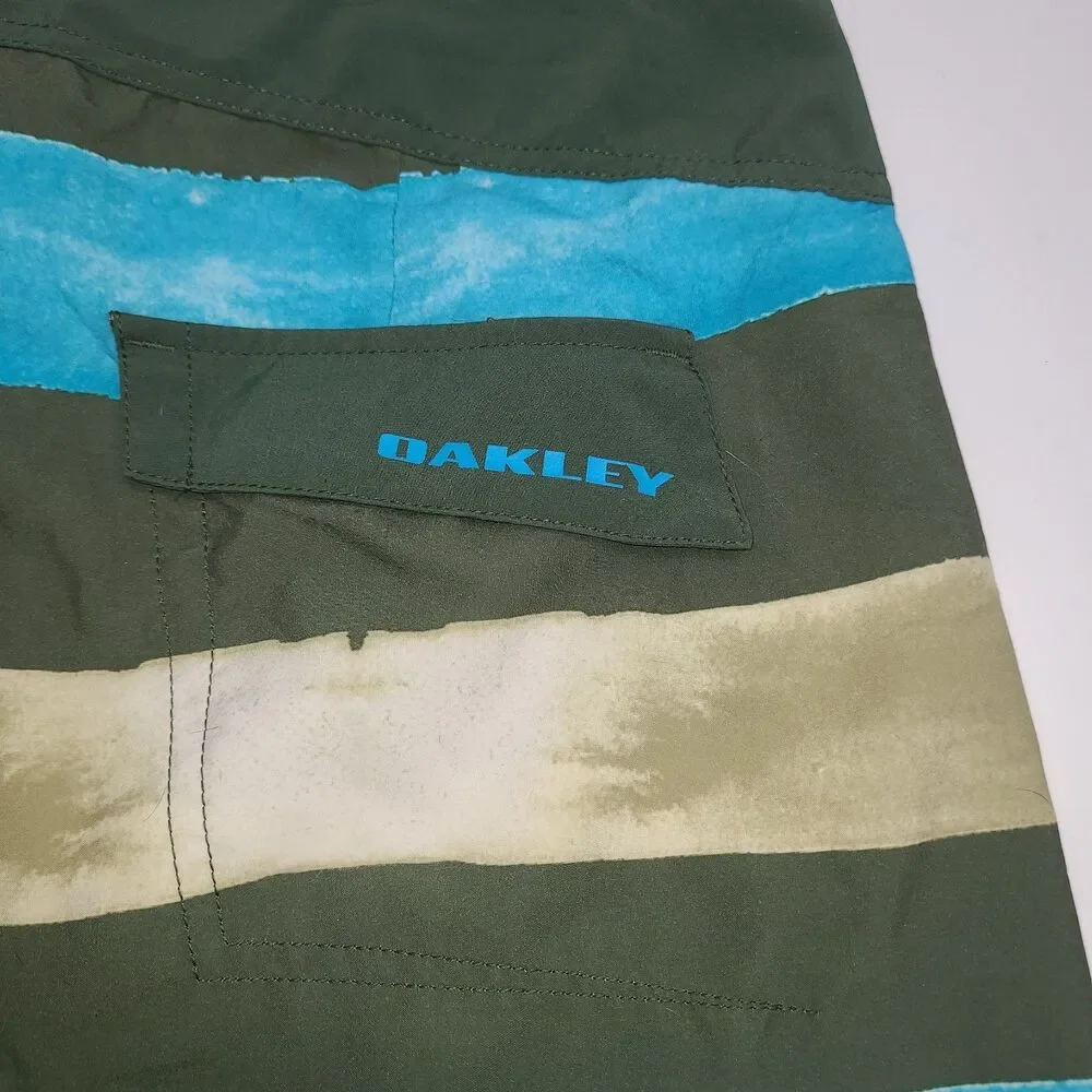 Oakley Crashing Wave board shorts with a multi-color stripe pattern. Men's 34